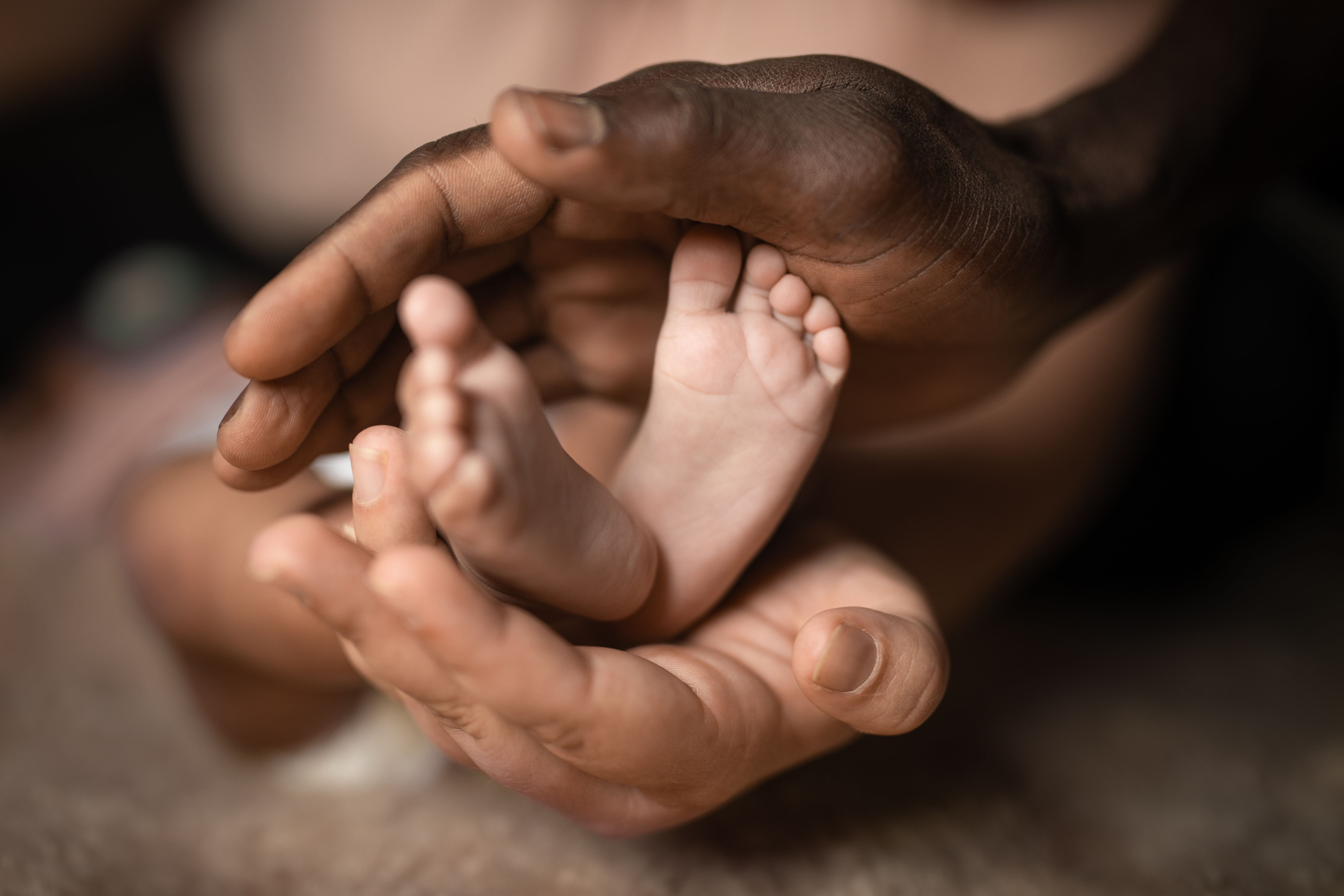 Family holding baby feet in hands